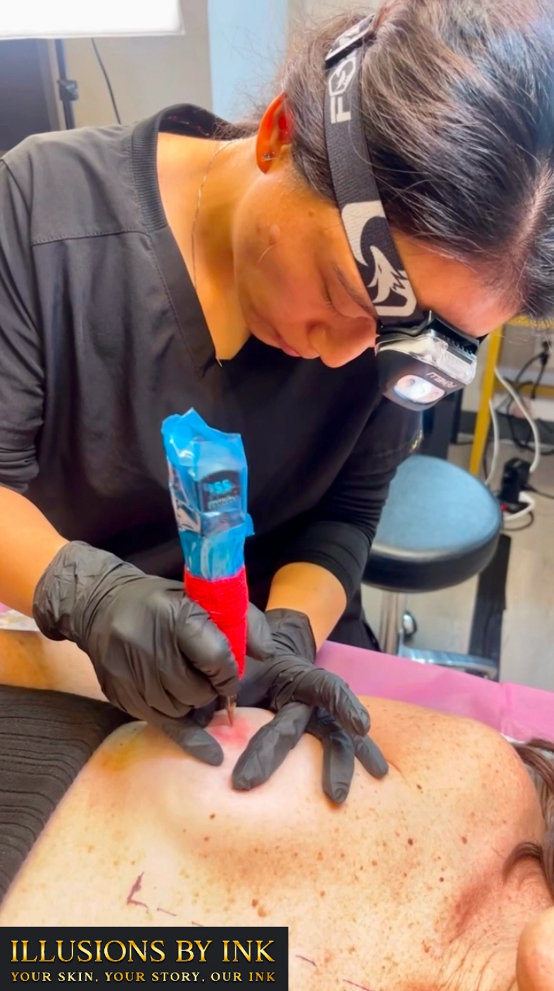 Paramedical tattoo artist performing 3D Nipple and Areola Tattooing on a post-mastectomy client at Illusions by Ink Studio.