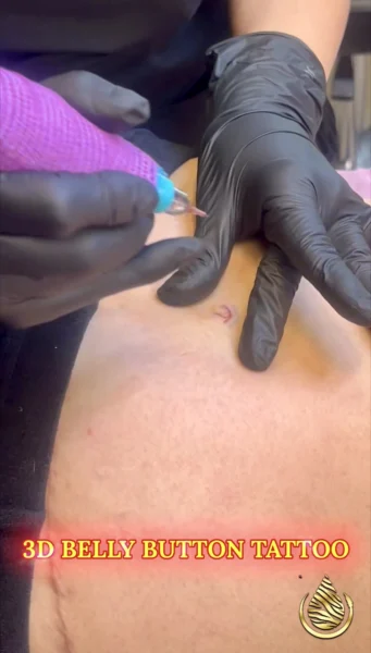 Illusions by Ink tattoo artist applying a 3D belly button tattoo using paramedical tattooing techniques.