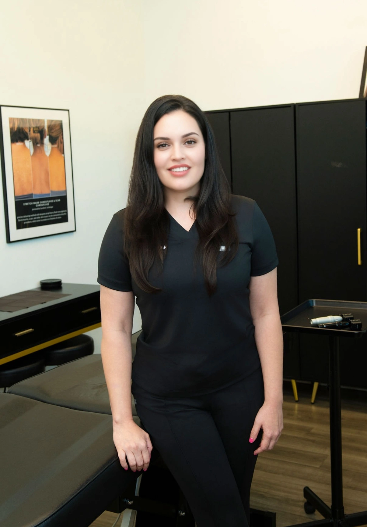 Master paramedical tattoo artist Elena Sanchez standing in her treatment studio at Illusions by Ink Studio in Dallas, Texas.